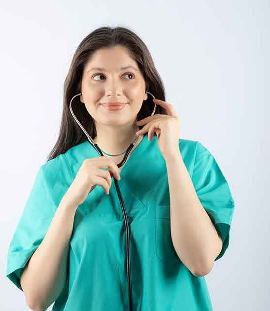 Compassionate nurse providing attentive care and assessment to a patient at The Caringhand Services