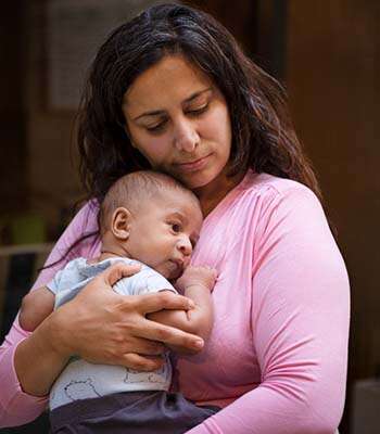 Professional baby care services by Caringhand Healthcare nurse providing comfort to infant