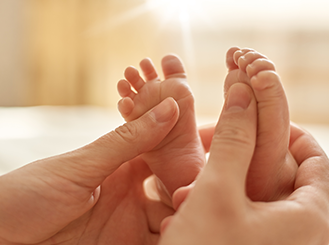 Baby caregiver providing infant massage