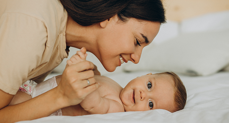 Professional baby caregiver playing with infant