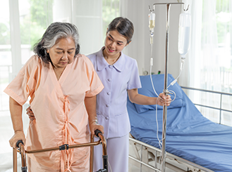 Caregiver helping post-surgical patient with mobility exercises