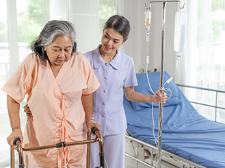 Qualified Caringhand nurse monitoring vital signs of elderly patient during home healthcare visit
