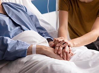 Professional caregiver monitoring patient vital signs